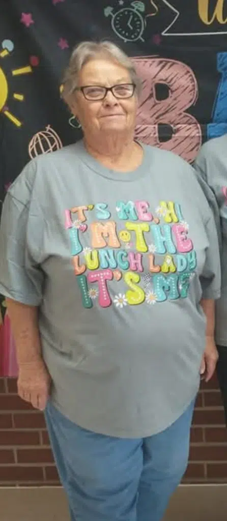 Woman wearing gray T-shirt with colorful slogan